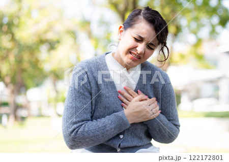 Caucasian woman chest pain in outdoor park, emergency of patient with injury. 122172801