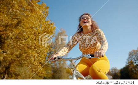 Confident Plus-Size Woman Enjoying a Bicycle Ride on a Crisp Autumn Morning. Generated image  122173411