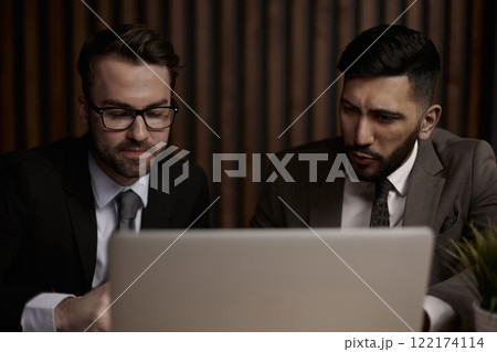 Two men discussing company growth, looking at rising graph on la 122174114