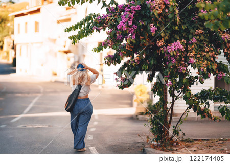 blonde girl in blue pants walking on the street in istanbul. tourist on princes islands in turkey 122174405