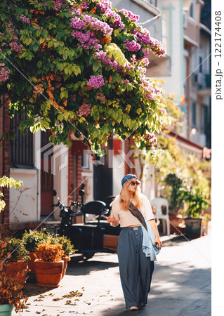 blonde girl in blue pants walking on the street in istanbul. tourist on princes islands in turkey 122174408