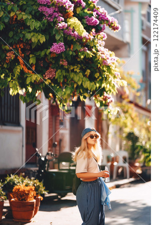 blonde girl in blue pants walking on the street in istanbul. tourist on princes islands in turkey 122174409