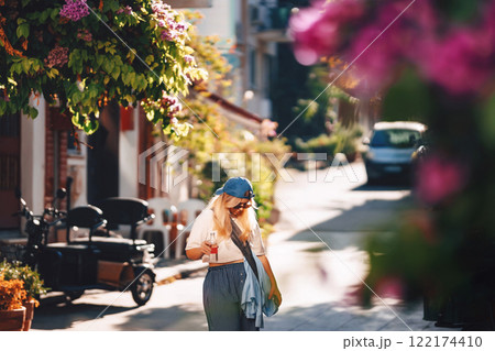 blonde girl in blue pants walking on the street in istanbul. tourist on princes islands in turkey 122174410