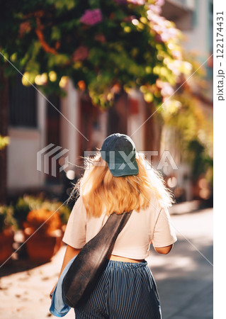 blonde girl in blue pants walking on the street in istanbul. tourist on princes islands in turkey 122174431
