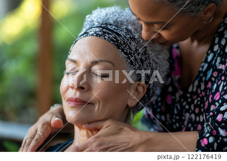 Mature woman enjoys relaxing massage at spa 122176419