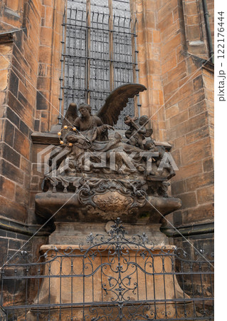 Gothic stone sculpture near old buildings in the old town of Prague, Czech Republic 122176444
