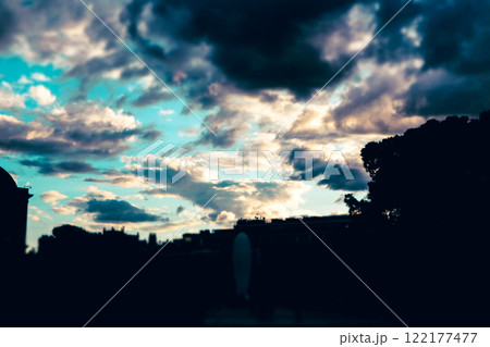 Beautiful blue cloudy sky in twilight. Day to the night. Heavy lights and dark clouds on a skyline. Real majestic dramatic sunrise sundown. Heaven. 122177477