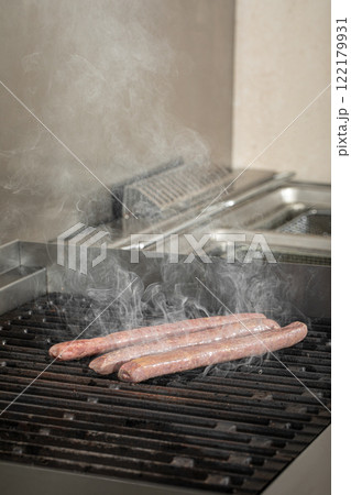 Grilling beef sausages with a smoke 122179931