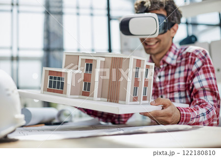 Virtual reality futuristic design technology. Architect or design engineer in VR headset for BIM technology Virtual reality futuristic design technology. Architect or design engineer in VR headset for BIM technology 122180810