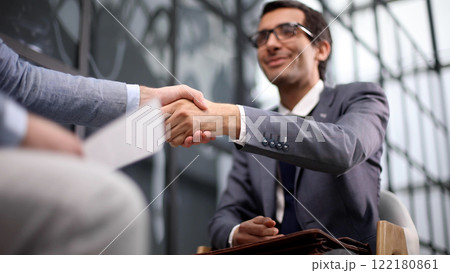 Shot of businessmen making a deal after viewing a document 122180861