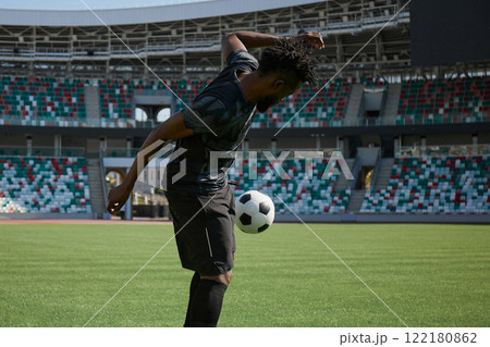 African American soccer player during match inside large stadium 122180862