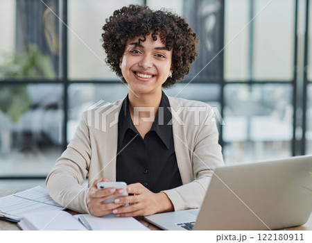 Portrait of Young Successful Caucasian Businesswoman Sitting at Desk Working on Laptop 122180911