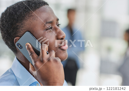 shot of confident young Afro-American man walking through lobby of busy office building, talking on smartphone and smiling shot of confident young Afro-American man walking through lobby of busy office building, talking on smartphone and smiling 122181242