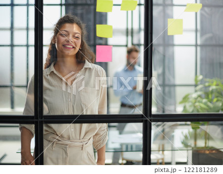 Smiling business woman looking out the window. 122181289