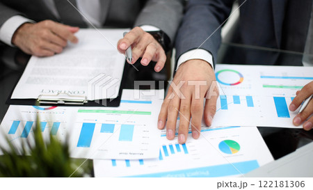 Businessman working at office desk, he is building a growing financial graph using wooden toy blocks. 122181306