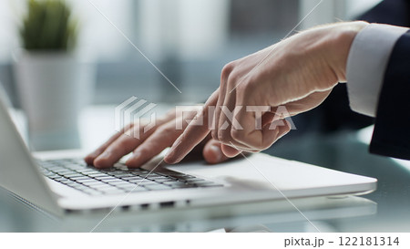 Young man presses his finger on the computer at the table in the office, close-up. Young man presses his finger on the computer at the table in the office, close-up. 122181314