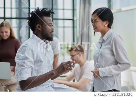 two businessmen talking against the background of their colleagues in the office two businessmen talking against the background of their colleagues in the office 122181320