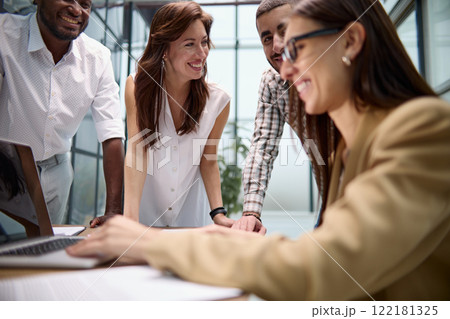 Colleagues lean on the conference table and discuss business, app UI and design. 122181325