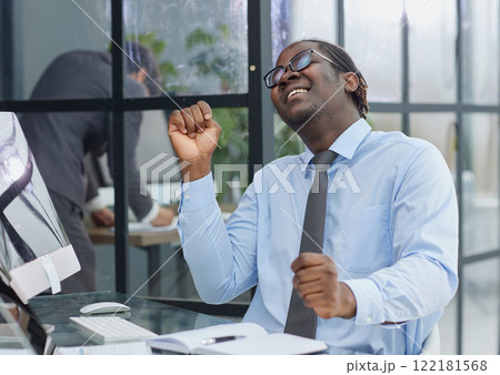 happy man working in the office. raised his hands joyfully 122181568