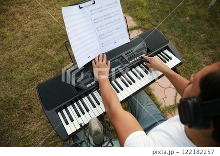 Boy Pianist Plays The Keyboard In An Outdoor Garden For A Private Party 122182257