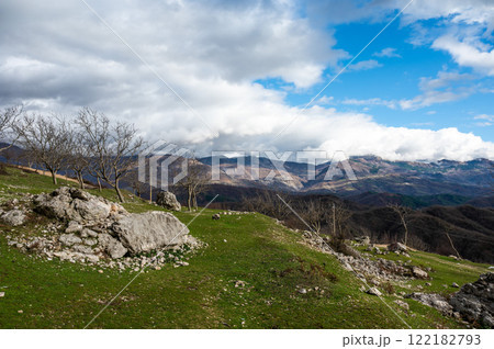 Fallen stone and rock formation with a mountain background at Gamti Mountain, Albania 122182793