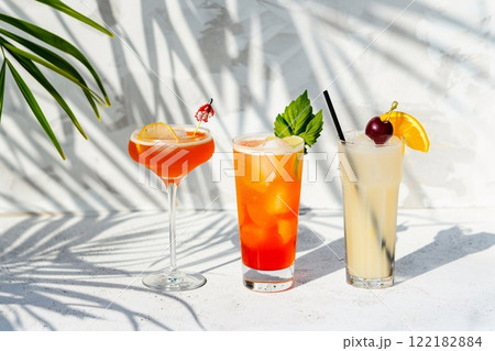 Colorful summer tropical and exotic cocktail glasses with palm shadow.Macro.AI Generative. 122182884