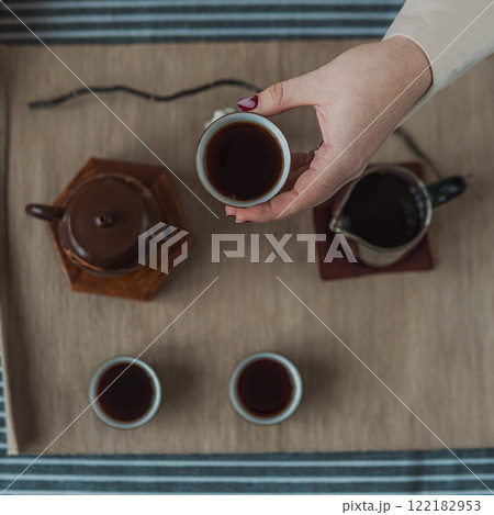 A beautiful and elegant tea ceremony featuring a traditional teapot and matching tea cups A beautiful and elegant tea ceremony featuring a traditional teapot and matching tea cups 122182953