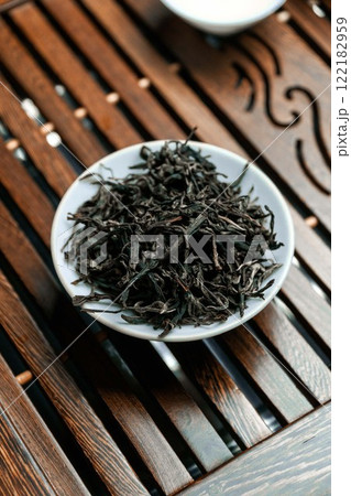 Dried Black Tea Leaves Beautifully Arranged on a Wooden Surface for Display and Enjoyment 122182959
