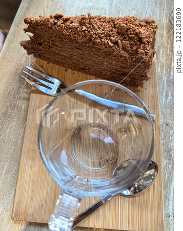 Delicious layered chocolate dessert served in a cozy cafe setting Delicious layered chocolate dessert served in a cozy cafe setting 122183699