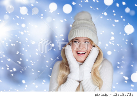 Blonde woman wearing warm mittens, knitted beanie hat and jumper, winter snow nature background with copyspace fashion and lifestyle idea 122183735