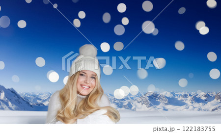 Blonde woman wearing warm mittens, knitted beanie hat and jumper, winter snow nature background with copyspace fashion and lifestyle idea 122183755