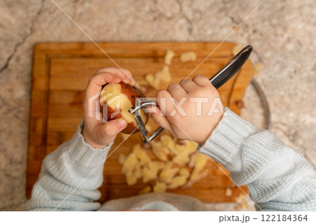 Child Peeling Potato 122184364