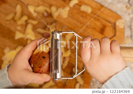 Child Peeling Potato Child Peeling Potato 122184369