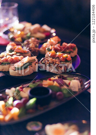 Bruschettas, on slices of toasted baguette garnished with basil Bruschettas, on slices of toasted baguette garnished with basil 122184406