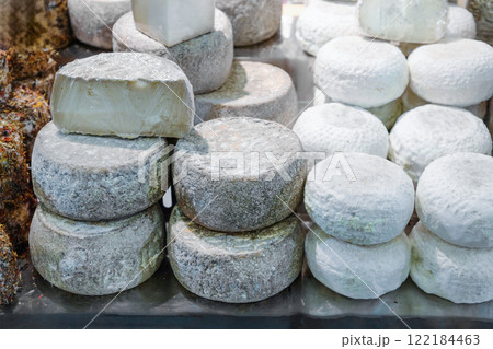 several different varieties of farmer's cheese lie on counter ready for sale 122184463