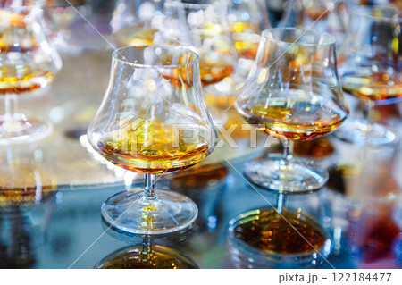 many glasses with strong alcohol stand on the table ready to drink 122184477