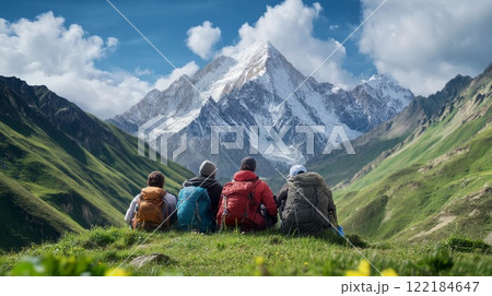Group of friends enjoying breathtaking mountain view during a sunny day in the countryside 122184647