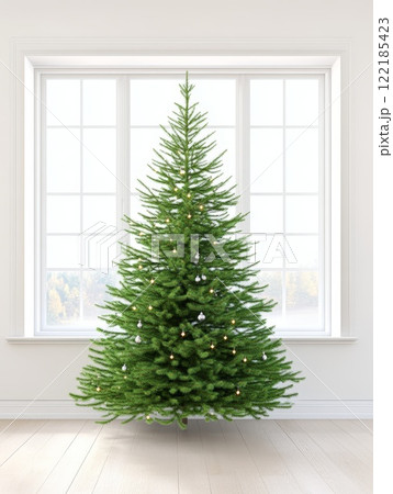 Childs hand holding a glittery transparent ornament with blurry Christmas lights behind winter holiday decor 122185423