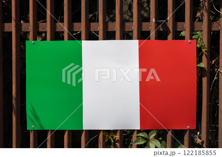 Italy flag on steel fence. Italian flags on the city street. High quality photo Italy flag on steel fence. Italian flags on the city street. High quality photo 122185855