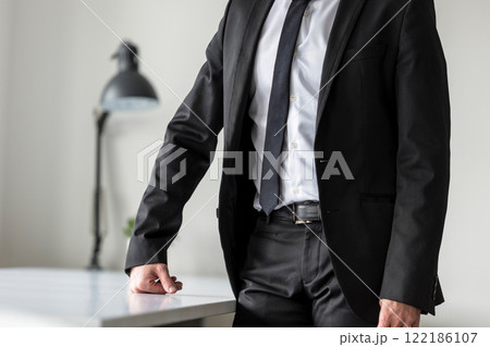 Businessman standing in his office waiting Businessman standing in his office waiting 122186107