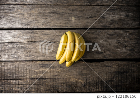 Bunch of fresh bananas on wooden boards 122186150
