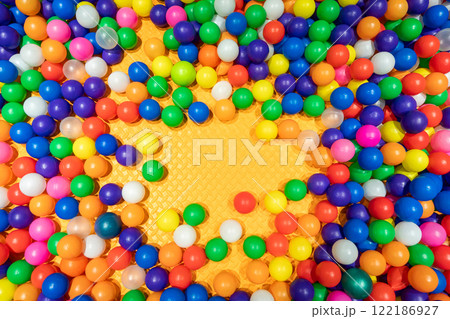 A cheerful and colorful ball pit perfect for kids' fun and playtime. 122186927