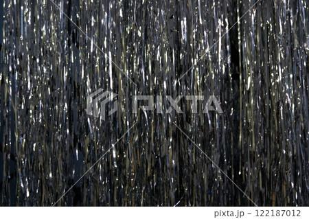 Silver foil decorations forming a photo zone for celebrating a birthday, anniversary or New Year's Eve party. The concept of celebrating Christmas and New Year. High quality photo 122187012