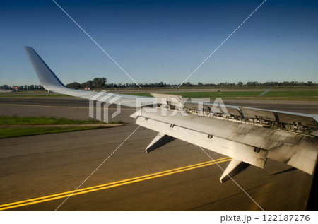 Aircraft Wing with Extended Spoilers A Close Up View on the Runway 122187276