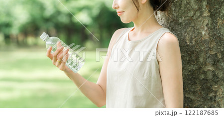 ペットボトルの水・ミネラルウォーター・白湯を飲むリラックスした女性 122187685