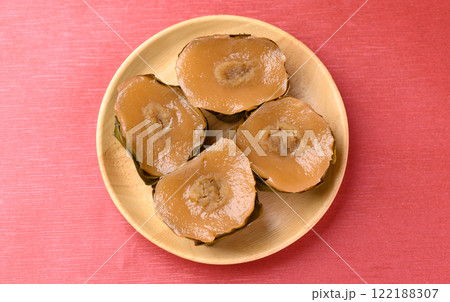 Sticky rice cake (Nian Gao), Chinese New Year cake on red background, Top view Sticky rice cake (Nian Gao), Chinese New Year cake on red background, Top view 122188307
