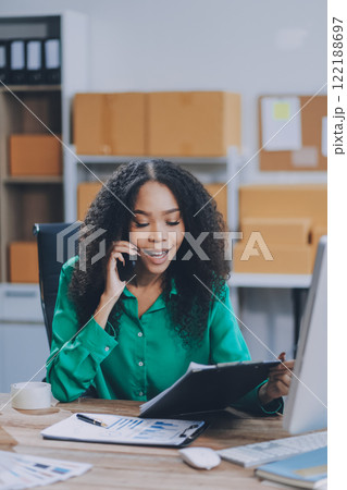 Portrait of Starting small businesses SME owners female entrepreneurs working on receipt box and check online orders to prepare to pack the boxes, sell to customers, SME business ideas online. 122188697