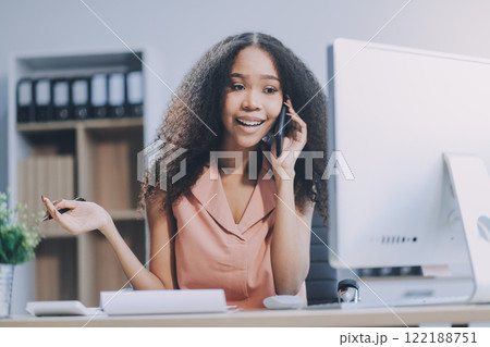 Young business woman entrepreneur using laptop and mobile phone at the working space. 122188751