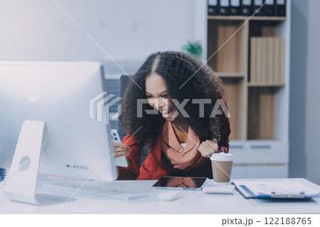 Excited african American woman sit at desk feel euphoric win online lottery, happy black woman overjoyed get mail at laptop being promoted at work, biracial girl amazed read good news at computer Excited african American woman sit at desk feel euphoric win online lottery, happy black woman overjoyed get mail at laptop being promoted at work, biracial girl amazed read good news at computer 122188765