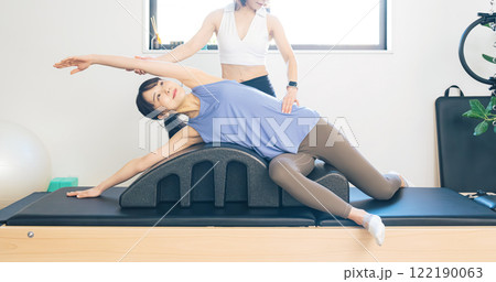 マシンピラティスのレッスンを受ける女性 122190063